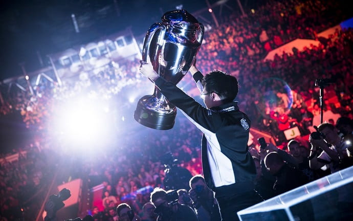 Esports tournament winner lifting championship trophy at professional gaming event